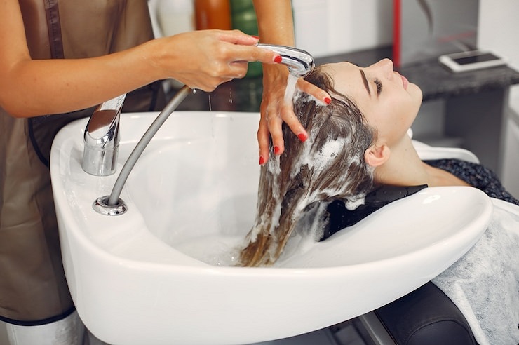 Woman washing head in a home place